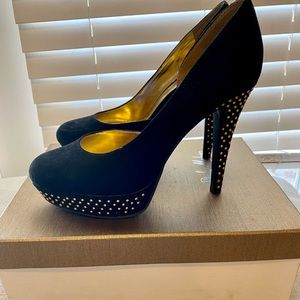 Woman’s gold studded heels
